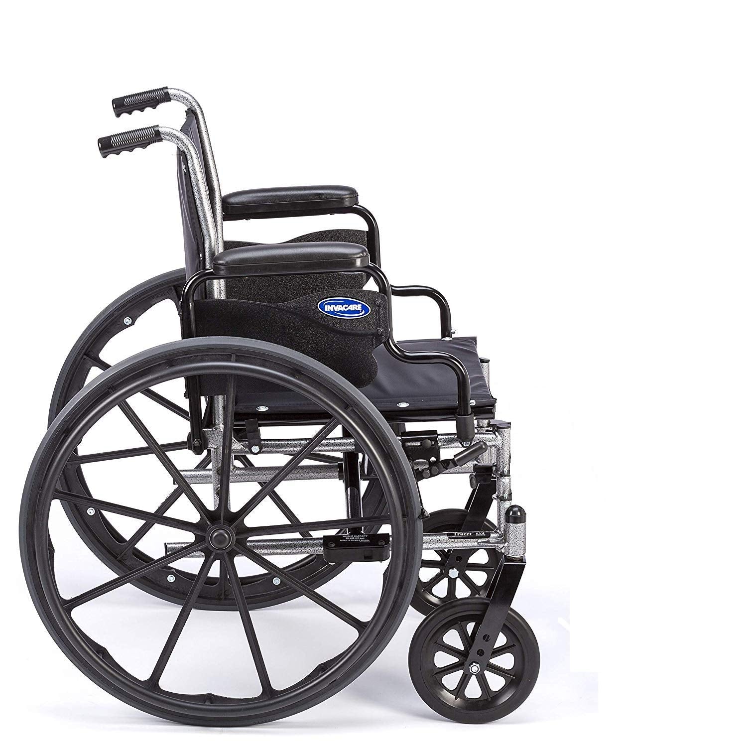 A side view of Invacare's Tracer SX5 wheelchair displaying the desk-length armpads for added convenience while sitting at a desk or table.  The image highlights the smooth urethane rear tires. The wheelchair does not contain legrests or footrests on the wheelchair.  The image is on a white background.